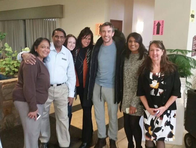 Actor Steve Coogan poses for a photo with staff at