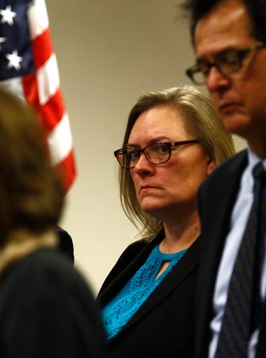 Aztec Mayor Sally Burbridge, center, listens as New Mexico Gov. Susana Martinez addresses the public Thursday during a press conference at the San Juan County Administration Building in Aztec after a fatal shooting at Aztec High School.