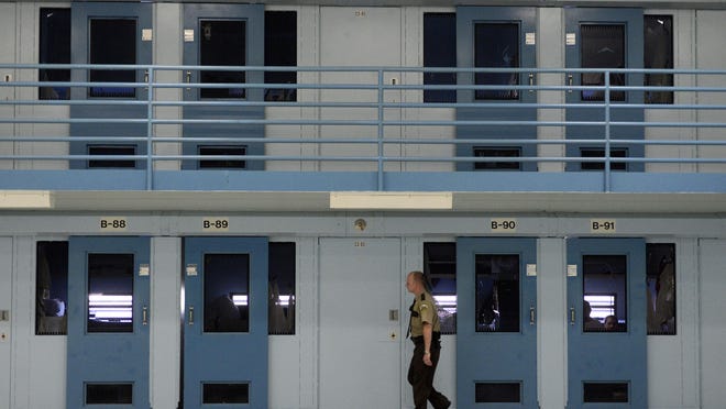 A guard checks on inmates in the Jameson Annex of the South Dakota State Penitentiary.(Elisha Page / Argus Leader)
