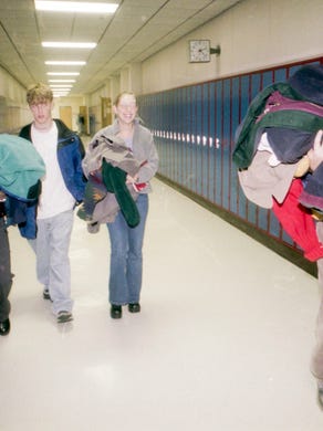 From left, West High School seniors Melanie Mullins, Christ Walker, Tovah Greenwood, and Patrick McGlothin carry an armload of coats to be donated for "Coats for the Cold" on November 19, 1999.