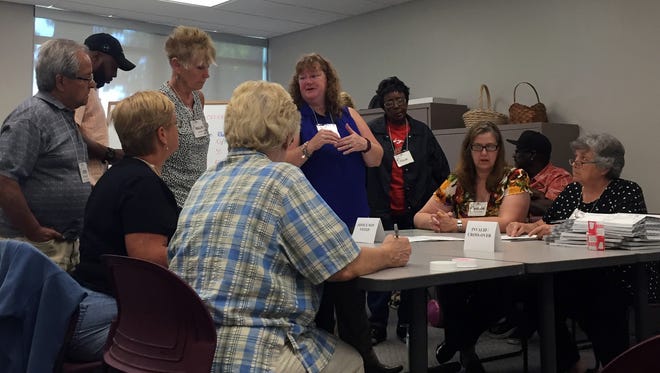 The recount team and candidates' representatives gather in the Calhoun County Clerk and Register of Deeds office to review votes cast in the Democratic primary for Bedford Township trustee.