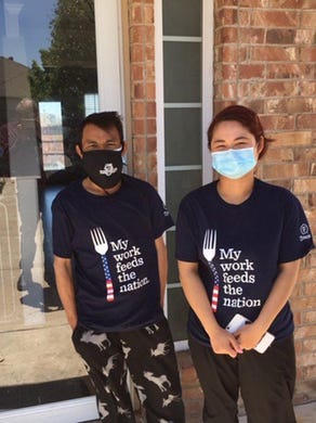 Kwey Baw, left, and his wife, Ehdah Baw, who work separate shifts at the Tyson plant so they can take care of their children, were told they had tested positive for COVID-19, even though they displayed no symptoms, and should quarantine for 14 days.