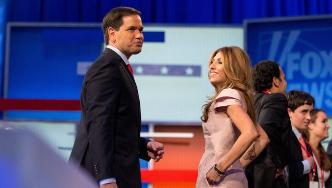 Republican presidential candidate Sen. Marco Rubio of Florida, stands on stage with his wife, Jeanette Dousdebes, following the first Republican presidential debate at the Quicken Loans Arena in Cleveland on Thursday.