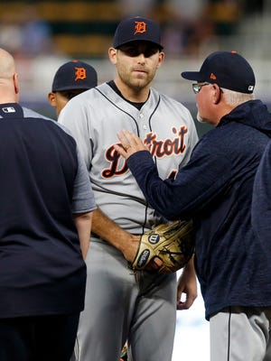 Tigers pitcher Matthew Boyd listens to manager Ron Gardenhire, right, before leaving the mound with a trainer during the fifth inning against the Twins on Tuesday in Minneapolis.