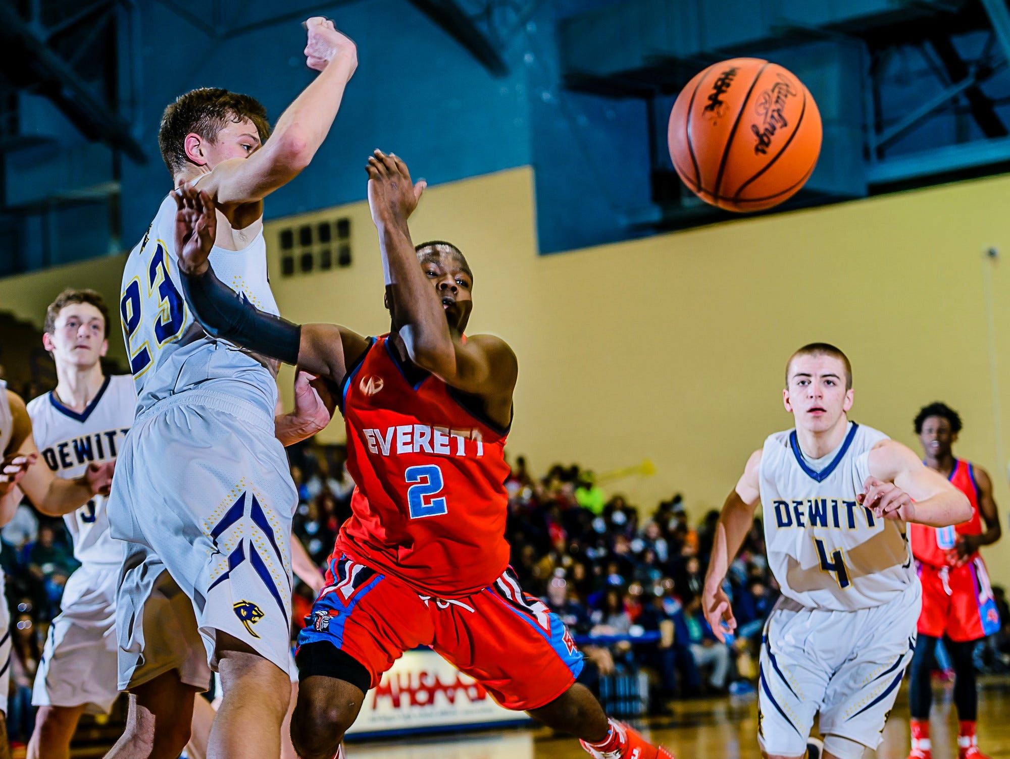 Nyreel Powell ,2, of Everett is fouled by Eddie Daley ,23, of DeWitt with 1:08 remaining in their Class A district semifinal game and DeWitt leading 46-45 Wednesday March 8, 2017 at Don Johnson Fieldhouse in Lansing. Powell would sink 1 of 2 freethrows to tie the game. KEVIN W. FOWLER PHOTO