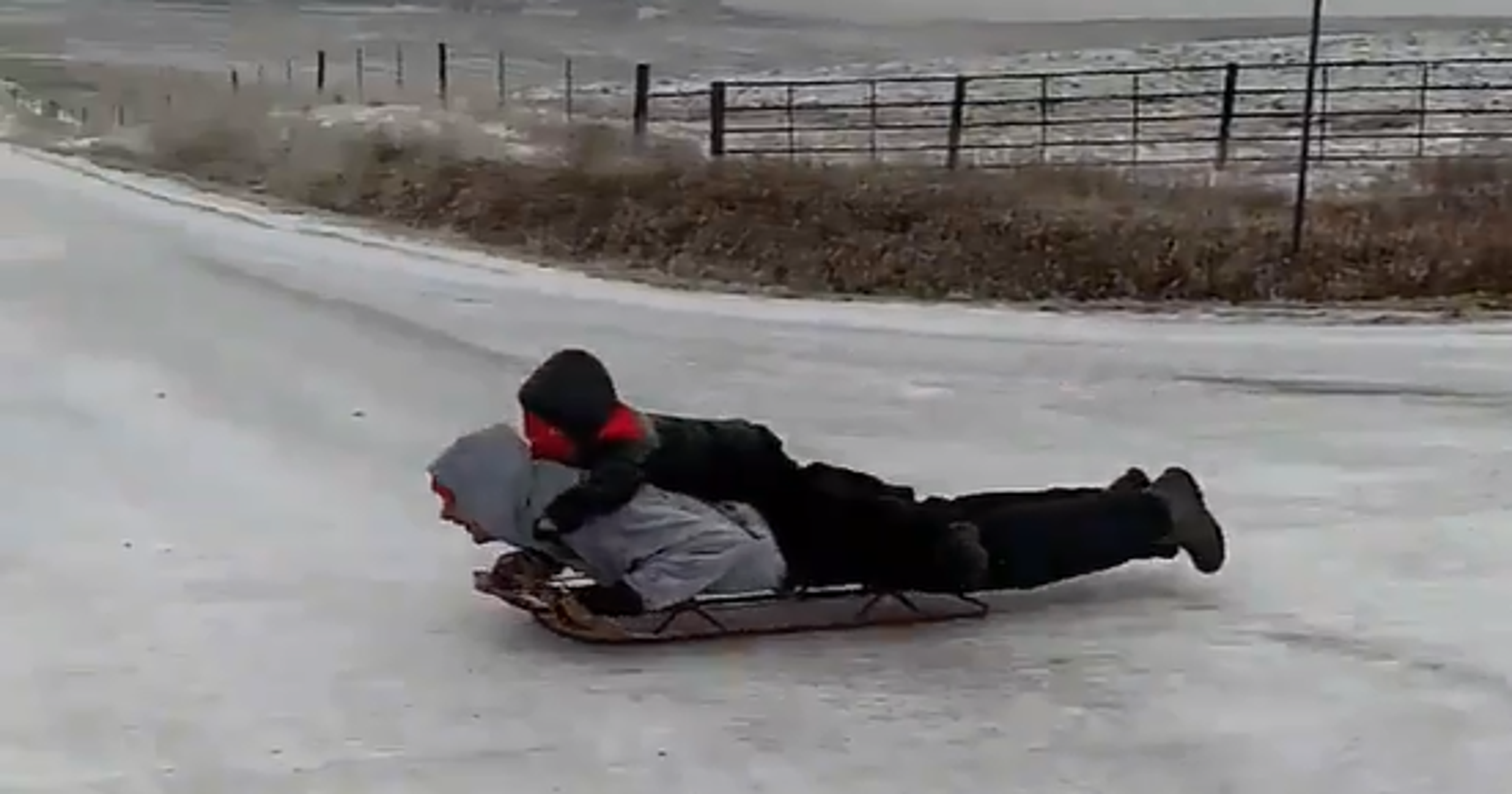 Iowans zip down icy road on sleds as seen in viral video
