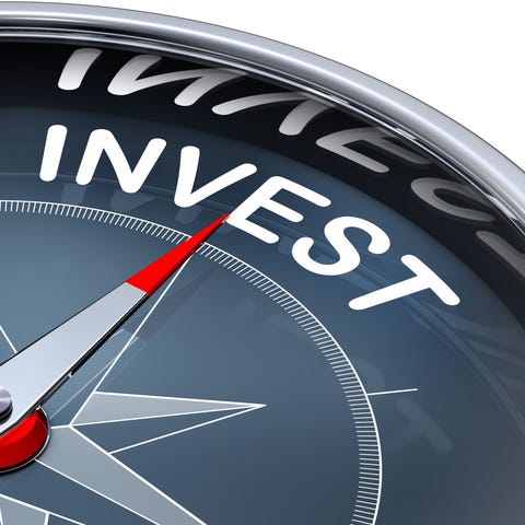 A compass pointing towards the word invest.