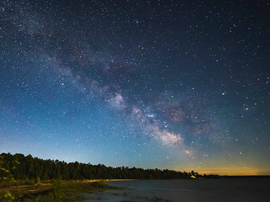The Milky Way is visible in the night sky over Headlands