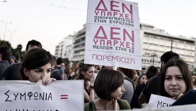 Leftist  youth hold placards reading "There is no agreement in eurozone -- there is no future in the European Union" during an anti-EU demonstration in Athens.