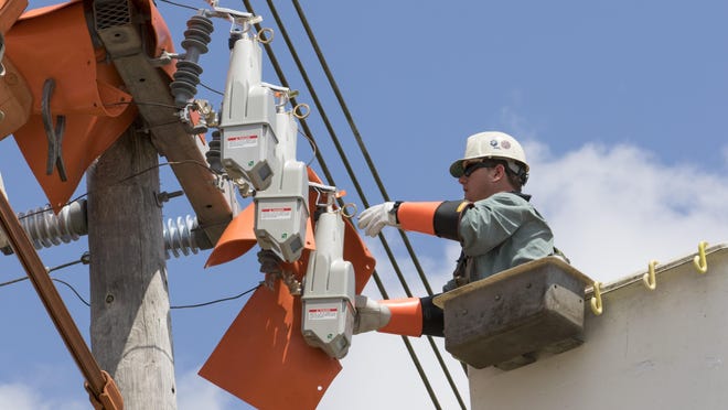 An FPL workers installs what’s called an “automated lateral switch” (Boca Raton earlier this year. The switches communicate with each other and can sometimes correct problems so a worker won’t have to go to a site.