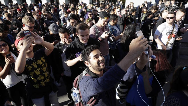 “Pokemon Go” players begin a group walk along the Embarcadero in San Francisco. “Pokemon Go” was an instant hit when it debuted in July, as millions of people discovered augmented reality and joined stampedes from Central Park to Sydney capturing Pokemon via their phones.