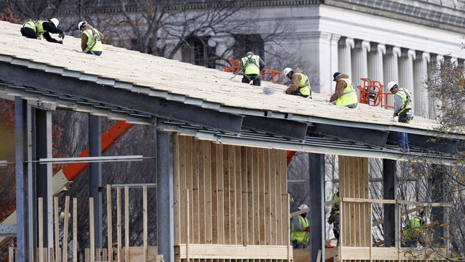 Construction continues on the presidential reviewing stand on Pennsylvania Avenue in front of the White House in Washington, Saturday, Nov. 26, 2016. The reviewing stand is where then President Donald Trump will view the inaugural parade on Jan. 20, 2017. (AP Photo/Alex Brandon)