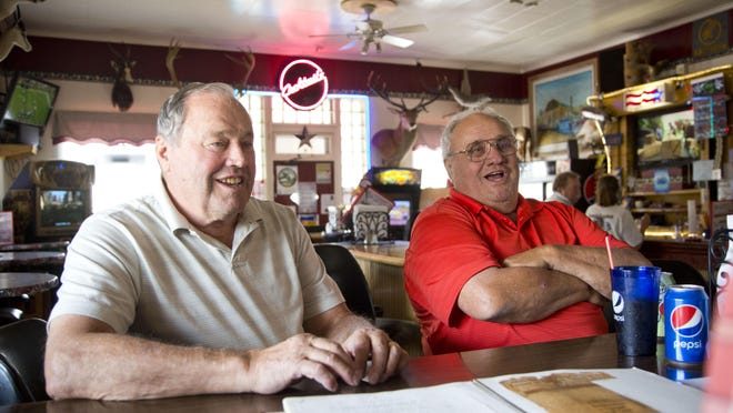 Ron “Pooner” Guisti, left, and his brother Brian “Punky” Guisti, prior owners of the American Bar, talk with other old-timers in 2015, the 100th anniversary of the Stockett Bar..