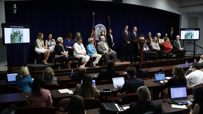 Pennsylvania Attorney General Josh Shapiro speaks during a news conference at the Pennsylvania Capitol in Harrisburg, Pa., Tuesday, Aug. 14, 2018. A Pennsylvania grand jury says its investigation of clergy sexual abuse identified more than 1,000 child victims. The grand jury report released Tuesday says that number comes from records in six Roman Catholic dioceses. The people seated were some of those affected by the clergy abuse. (AP Photo/Matt Rourke)