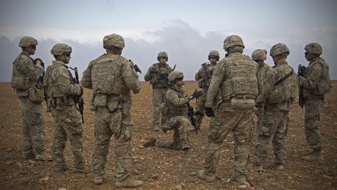 In this Nov. 7, 2018, photo released by the U.S. Army, U.S. soldiers gather for a brief during a combined joint patrol rehearsal in Manbij, Syria. The United States’ main ally in Syria on Thursday, Dec. 20, 2018, rejected President Donald Trump’s claim that Islamic State militants have been defeated and warned that the withdrawal of American troops would lead to a resurgence of the extremist group.