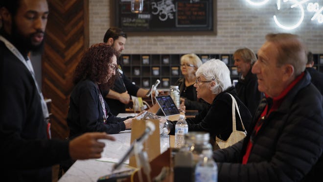 In this Feb. 19, 2019 photo, a group of seniors from Laguna Woods Village consult with sales associates at Bud and Bloom cannabis dispensary in Santa Ana, Calif. The seniors boarded a bus for the pot shop and spent hours choosing from a variety of cannabis-infused products, including candies, drinks and weed. (AP Photo/Jae C. Hong)