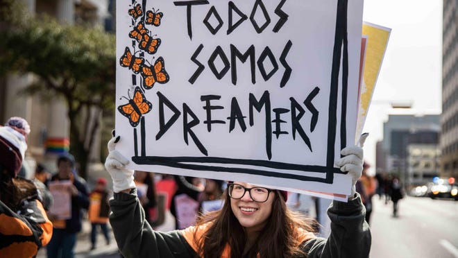 Brenda Godoy holds a banner that read Todos Somos Dreamers (We all are Dreamers) during a November 2019 a rally by immigrant youth and advocates.