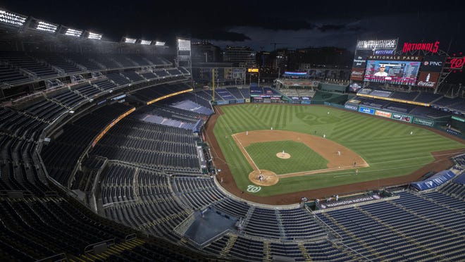 The stands are empty during the eighth inning of an exhibition game between the Baltimore Orioles and the Washington Nationals Tuesday at Nationals Park in Washington, where the defending world champions will host an opening day game against the New York Yankees Thursday night.