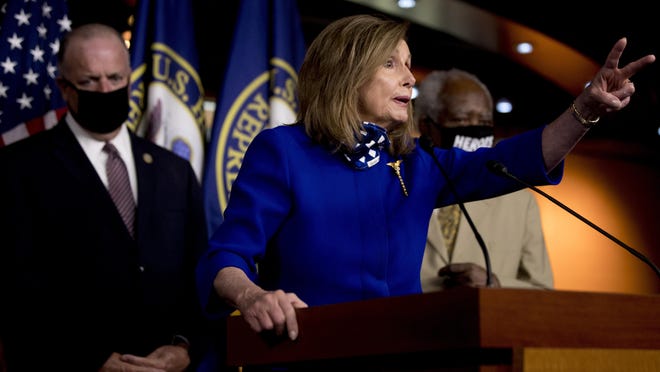 House Speaker Nancy Pelosi of Calif., accompanied by Rep. Dan Kildee, D-Mich., left, and Rep. Danny Davis, D-Ill., right, speaks at a news conference on Capitol Hill in Washington, Friday, July 24, 2020, on the extension of federal unemployment benefits.