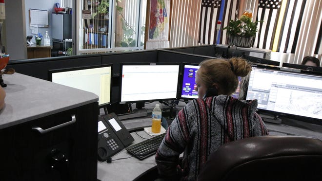 Dispatcher Charity Graves takes a call from a citizen while working in the City of Brownwood's dispatch center.