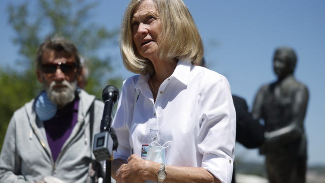Janet Johnson of Pawcatuck, Ct., front, speaks at a news conference while her husband, Norman, looks on after the sentencing hearing Wednesday, July 1, 2020, for James Curtis Clanton in the death of Helene Pruszynski, Janet Johnson's younger sister, four decades ago in Castle Rock, Colo. Clanton has been sentenced to life in prison.