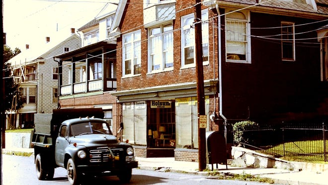This photo from Ranshaw, Pennsylvania, taken in 1973 shows Greg Zyla's grandfather's store with the Holsum bread logos at 251 Main St. and the family porch on the house to the left at 247 Main St. Our car author stood on that porch until 1958 watching all the cars and trucks pass by. The photo shows one of the many Studebaker coal trucks that drove by back then.