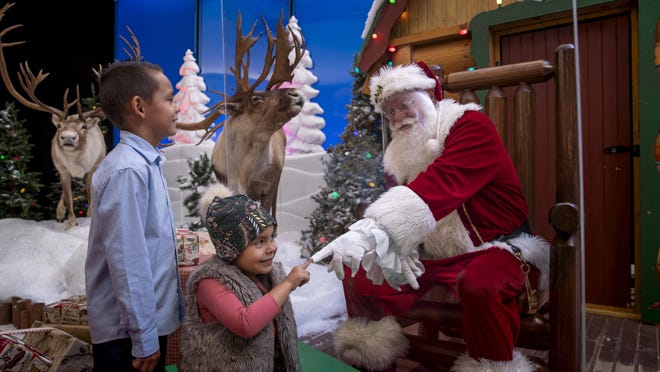 Santa is now in his wonderland at Cabela's and Bass Pro Shops, greeting visitors from behind his "Magic Santa Shield."