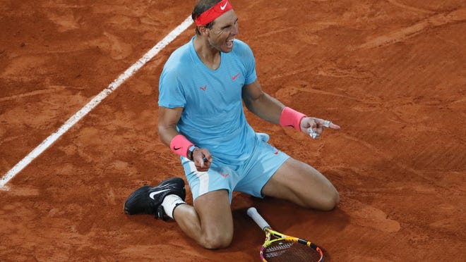 Spain's Rafael Nadal celebrates winning the final match of the French Open tennis tournament against Serbia's Novak Djokovic in three sets, 6-0, 6-2, 7-5, at the Roland Garros stadium in Paris, France, Sunday, Oct. 11, 2020.