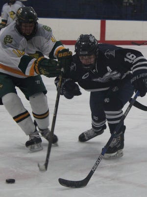Cranbrook Kingswood's Joey Dumas (right) battles for the puck with Grosse Pointe North's Alex Batts during Wednesday's game.