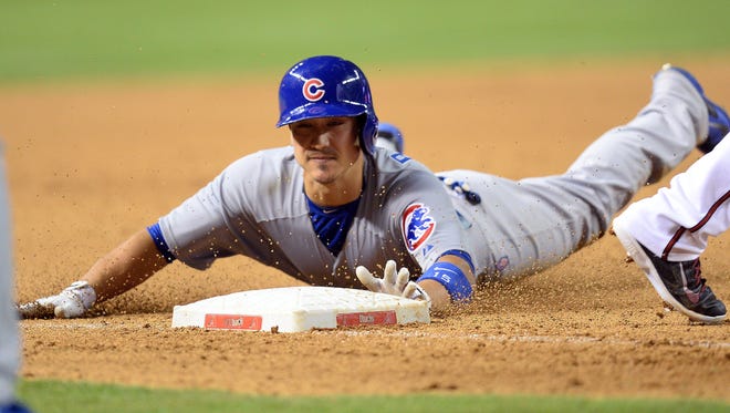 Chicago Cubs second baseman Darwin Barney (15) slides into third base with a triple in the ninth inning against the Arizona Diamondbacks at Chase Field.