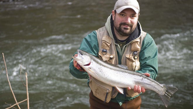 Dan Planton shows off the steelhead he caught near the Big Creek Fish Hatchery in Astoria in January 2010.