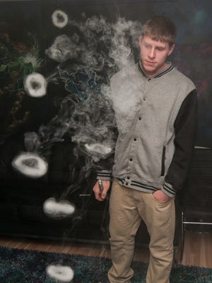 Adam Cavanaugh, 20, of Cold Spring, blows "vape rings" at the shop. Cavanaugh, Galaxy Vapors' official smoke tricks artist, said he has been performing tricks and creating videos for about two years.