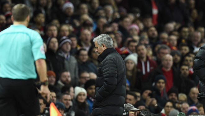 Mourinho leaves the touchline after referee Jonathan Moss sent him to the stands.