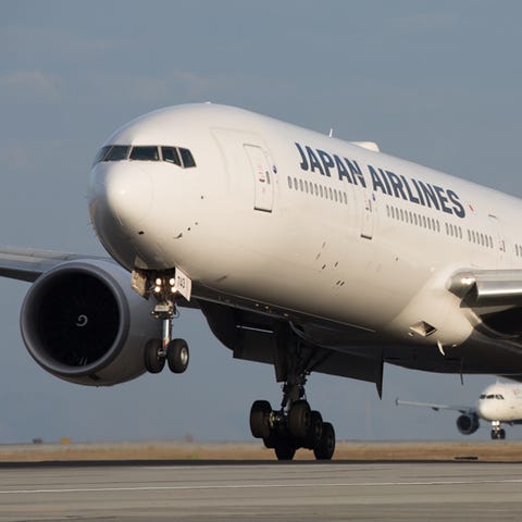 A Japan Airlines Boeing 777 lands from Tokyo at Sa