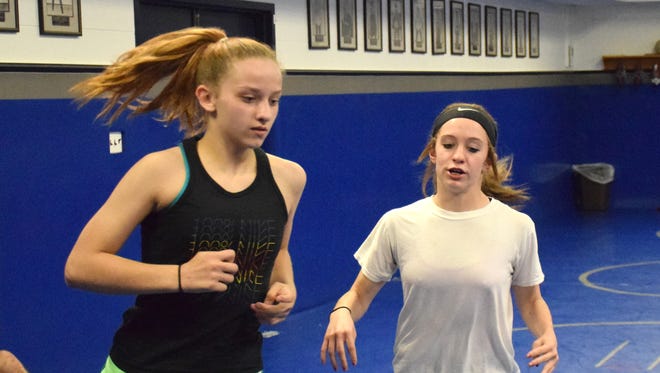 Brianna Reep, 13, left, and Jaylee Hatcher, 12, both of Stuarts Draft, warm up before practice with the Mat Pack Wrestling Club in the wrestling room at Washington & Lee University in Lexington, Va., on Wednesday, May 10, 2017.
