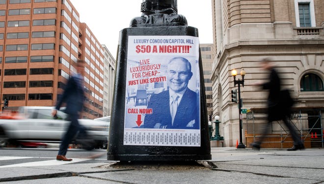 A sign criticizing Environmental Protection Agency Administrator Scott Pruitt is seen posted on the base of a utility pole on the corner of H Street NW and 13 Street NW in Washington, Friday, April 6, 2018. Pruitt is currently embroiled in controversy related to an apartment he rented from a Capitol Hill lobbyist for $50 a night, personnel issues at the EPA, and accusations of wasting taxpayer money.  