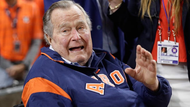 Former President George H. W. Bush prepares to throw out the ceremonial first pitch before game five of the 2017 World Series between the Houston Astros and the Los Angeles Dodgers at Minute Maid Park in 2017.