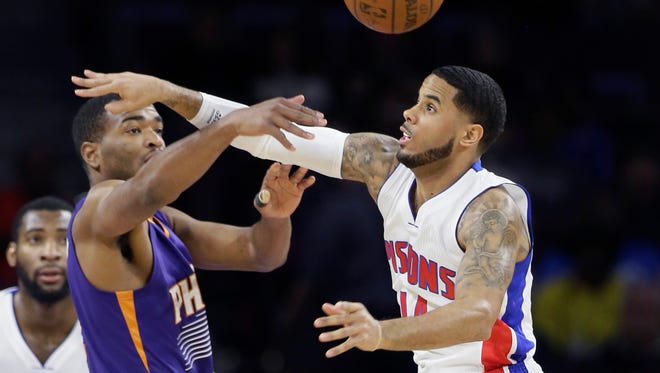 Detroit Pistons guard D.J. Augustin, right, knocks the ball away from Phoenix Suns forward T.J. Warren during the first half of an NBA basketball game in Auburn Hills, Mich., Wednesday, Nov. 19, 2014. (AP Photo/Carlos Osorio)