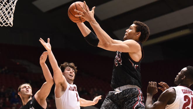 South Carolina Gamecocks forward Michael Carrera (24) grasps a rebound over Alabama Crimson Tide guards Riley Norris (1) and Rodney Cooper (21) as well as teammate forward Laimonas Chatkevicius (14) during the second half at Coleman Coliseum. Alabama won 59-51.