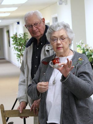Pictured are Bob and Bettye McKinnon with a souvenir cup from Bob's mother from 1905 Atlantic City.