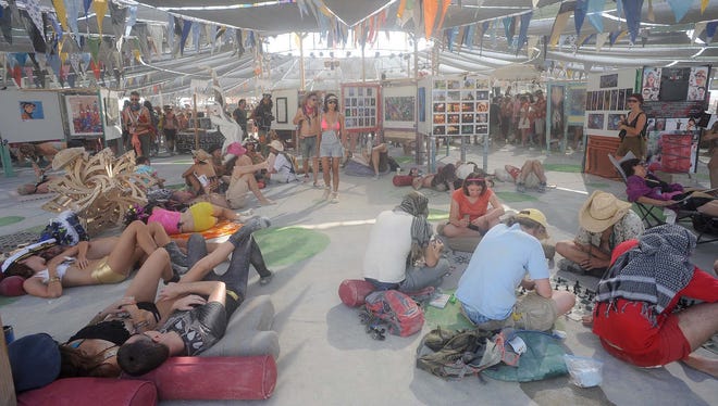 People relax inside Center Camp during Burning Man 2013.