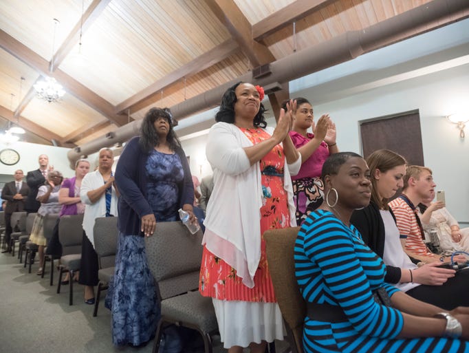 The congregation applauds during a special worship
