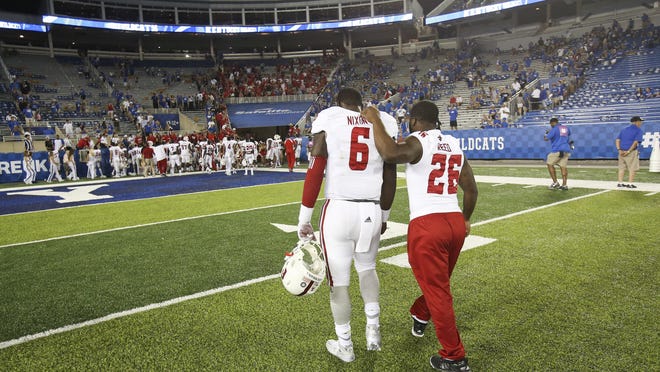 UL quarterback Jalen Nixon (6), whose Cajun career is done after he broke an ankle in Saturday's loss at New Mexico State, walks off the field with then-teammate Effrem Reed walk off the field following a loss at Kentucky last season.