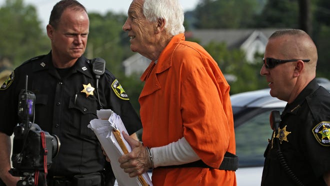 Former Penn State University assistant football coach Jerry Sandusky, center, arrives at the Centre County Courthouse for an appeals hearing about whether he was improperly convicted four years ago, in Bellefonte, Pa. Friday, Aug. 12, 2016. (AP Photo/Gene J. Puskar)