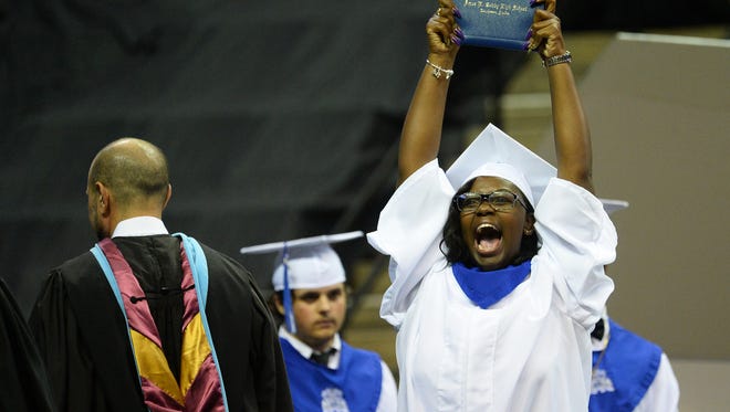 Shatera Baker celebrates after receiving her diploma from Amos P. Godby High School, Saturday evening, May 26, 2018 in the Tucker Civic Center.