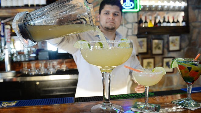 Hugo Caballero Jr. pours a King Margarita at La Buena Vida on Tuesday, in Fort Collins. The giant drink will be available this summer.