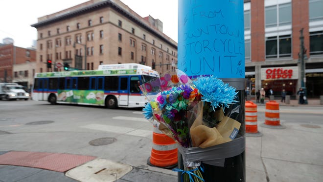 A makeshift memorial put up by Denver Police is affixed to a pole early Wednesday, Feb. 1, 2017, near the scene where a contract transit security officer was shot and killed late Tuesday, Jan. 31 in Denver. Police have not released any details about the shooting, which took place by the city's main transit hub, Union Station. (AP Photo/David Zalubowski)