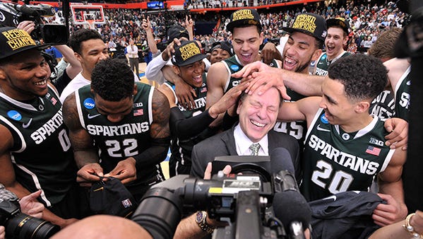 The Spartans mess up Tom Izzo's hair during their postgame celebration Sunday.