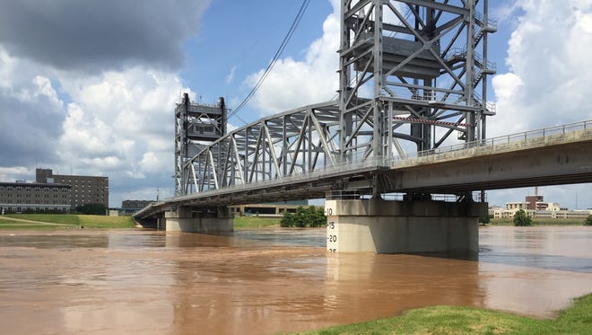 A Pineville man drawn to the swollen Red River (shown here last week) is being credited with saving a man who jumped Tuesday afternoon from the Jackson Street bridge, according to police.