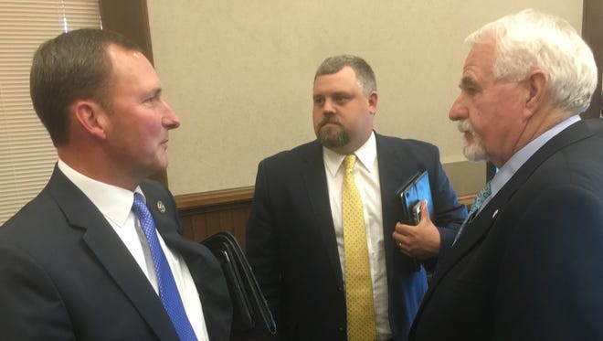 Montgomery County Sheriff John Fuson, left, celebrates the County Commission's unanimous vote Monday evening in support of a $1.9 million land purchase for a public safety training complex with Commissioners Brandon Butts and Ed Baggett, right.